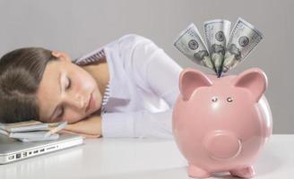 woman saving US Dollars in piggy bank photo