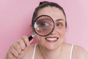 woman looking true magnifying glass photo