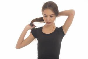 Young attractive smiling woman holding her strong hair photo