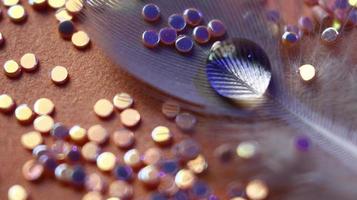 Close-up Of water drop with glitter on it in different colorful loghts in Karachi Pakistan 2022 photo