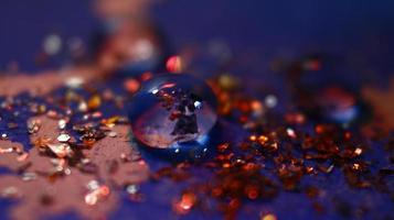 Close-up Of water drop with glitter on it in different colorful loghts in Karachi Pakistan 2022 photo