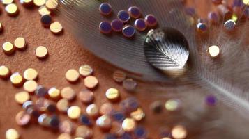 Close-up Of water drop with glitter on it in different colorful loghts in Karachi Pakistan 2022 photo
