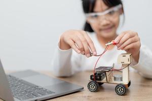 Asia students learn at home in coding robot cars and electronic board cables in STEM, STEAM, mathematics engineering science technology computer code in robotics for kids concept. photo
