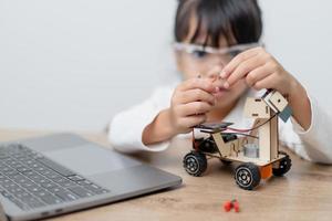 Asia students learn at home in coding robot cars and electronic board cables in STEM, STEAM, mathematics engineering science technology computer code in robotics for kids concept. photo