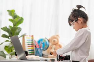 Asia students learn at home in coding robot cars and electronic board cables in STEM, STEAM, mathematics engineering science technology computer code in robotics for kids concept. photo