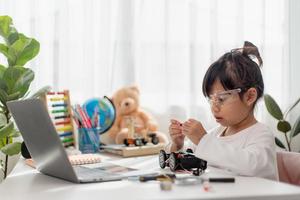 Asia students learn at home in coding robot cars and electronic board cables in STEM, STEAM, mathematics engineering science technology computer code in robotics for kids concept. photo