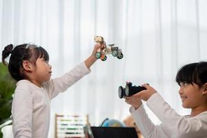 Asia students learn at home in coding robot cars and electronic board cables in STEM, STEAM, mathematics engineering science technology computer code in robotics for kids concept. photo