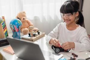 Asia students learn at home in coding robot cars and electronic board cables in STEM, STEAM, mathematics engineering science technology computer code in robotics for kids concept. photo