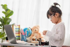 Asia students learn at home in coding robot cars and electronic board cables in STEM, STEAM, mathematics engineering science technology computer code in robotics for kids concept. photo