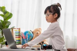 Asia students learn at home in coding robot cars and electronic board cables in STEM, STEAM, mathematics engineering science technology computer code in robotics for kids concept. photo