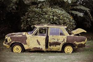 Yellow vintage broken car photo