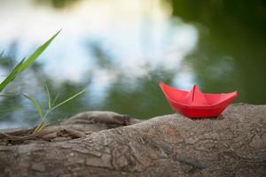 Red paper boat or Origami with nature photo