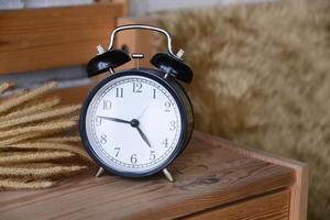 Retro Alarm Clock on wooden desk photo