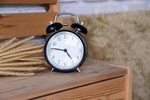 Retro Alarm Clock on wooden desk photo