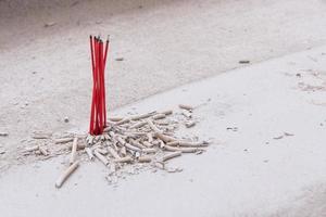 incense sticks in ash pot photo