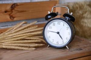 Retro Alarm Clock on wooden desk photo