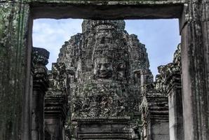 Prasat Bayon with smiling stone faces is the central temple of Angkor Thom Complex, Siem Reap, Cambodia. Ancient Khmer architecture and famous Cambodian landmark, World Heritage. photo
