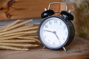 Retro Alarm Clock on wooden desk photo