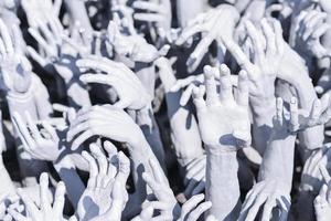 Abstract hands statue from Hell at Rong Khun White Temple, Thailand photo