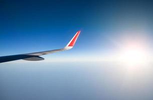 Wing of an airplane flying in the sky photo