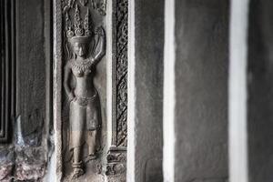 Detail of stone carvings of Apsara is a beautiful and seductive girl of Hindu mythology at Angkor Wat, Cambodia photo