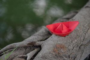 Red paper boat or Origami with nature