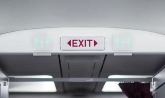 Exit and toilet sign on plane photo