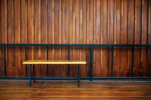 wooden bench against wooden wall on the parquet photo