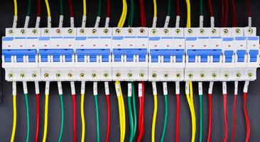 Close up circuit breakers and wire in control panel photo