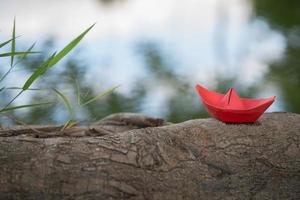 Red paper boat or Origami with nature photo