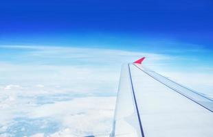 Wing of an airplane flying in the sky photo