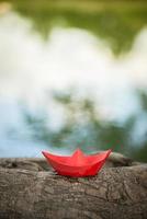 Red paper boat or Origami with nature photo
