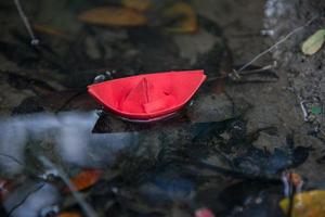 Red paper boat or Origami with nature photo