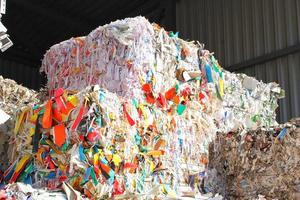 Wastepaper compact texture pile for recycling on sorting plant. Technology of reuse materials. Stack of shredded paper. Save the planet ecology concept. Industry of reduced pollution factory. Close-up photo