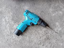 Cordless drill with drill bit working also as screw gun. photo