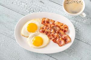 Fried eggs with bacon photo