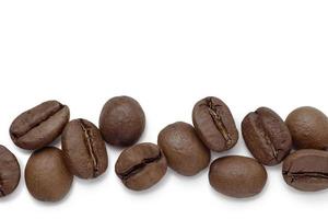 Fresh roasted coffee beans with leaves, isolated on white background photo