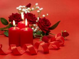 Candles, ribbon and beautiful flowers for the holiday. Festive concept for Valentine's Day, Mother's Day or Birthday photo