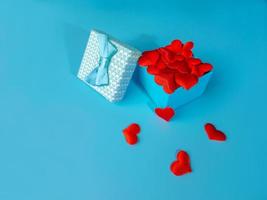 A gift for Valentine's day, Birthday or Christmas. Box with hearts on a blue background The concept of Valentine's day photo