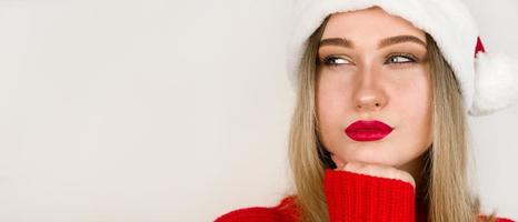 Close up portrait of santa woman looking at copyspace having thoughts about future events. Winter holidays and christmas concept photo