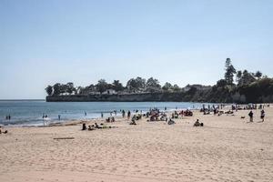 People enjoying and relaxing at Santa Cruz beach during sunny day photo