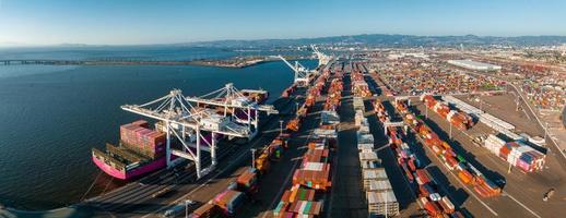 The Oakland Outer Harbor aerial view. Loaded trucks moving by Container cranes. photo