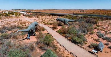 Allosaurus fragilis as well as Tyrannosaurus Rex or T-eEx dinosaurs in the Moab desert photo