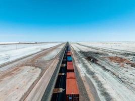 Cargo train passing by the desert Nevada, USA near Salt Flats. photo