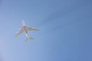 Airplane flying in mid-air with clear blue sky in the background photo