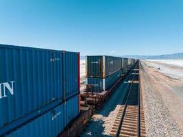 Cargo train passing by the desert Nevada, USA near Salt Flats. photo