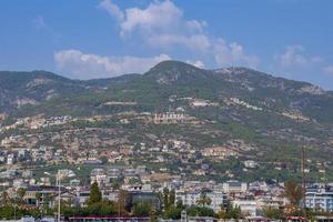 Distant view of Alanya text with heart shape on majestic mountain in city photo