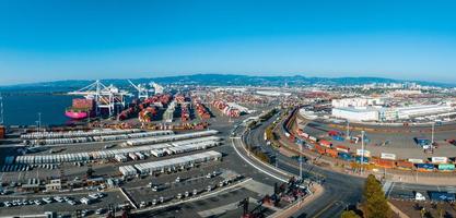 The Oakland Outer Harbor aerial view. Loaded trucks moving by Container cranes. photo