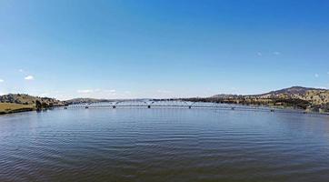 The panoramic view of Bethanga Bridge is a steel truss road bridge that carries the Riverina Highway across Lake Hume, an artificial lake on the Murray River in Australia. Image by drone flying. photo