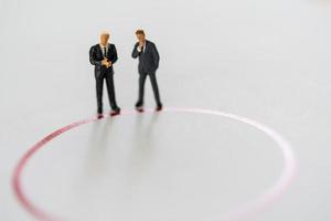 Miniature people businessman standing on a line border of a circle with copy space. Investment analysis, investment to thinking and planning.